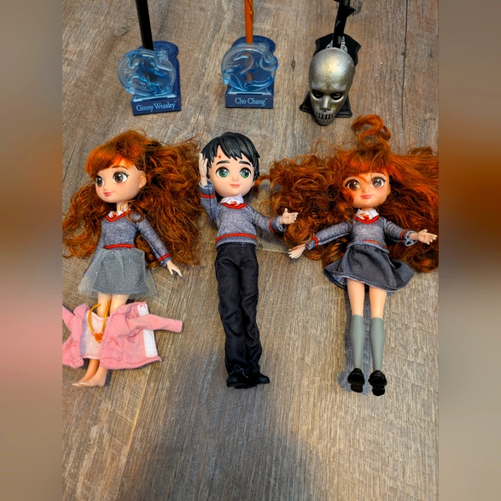 Harry Potter doll, 2 Hermione dolls, and 3 wands with stands